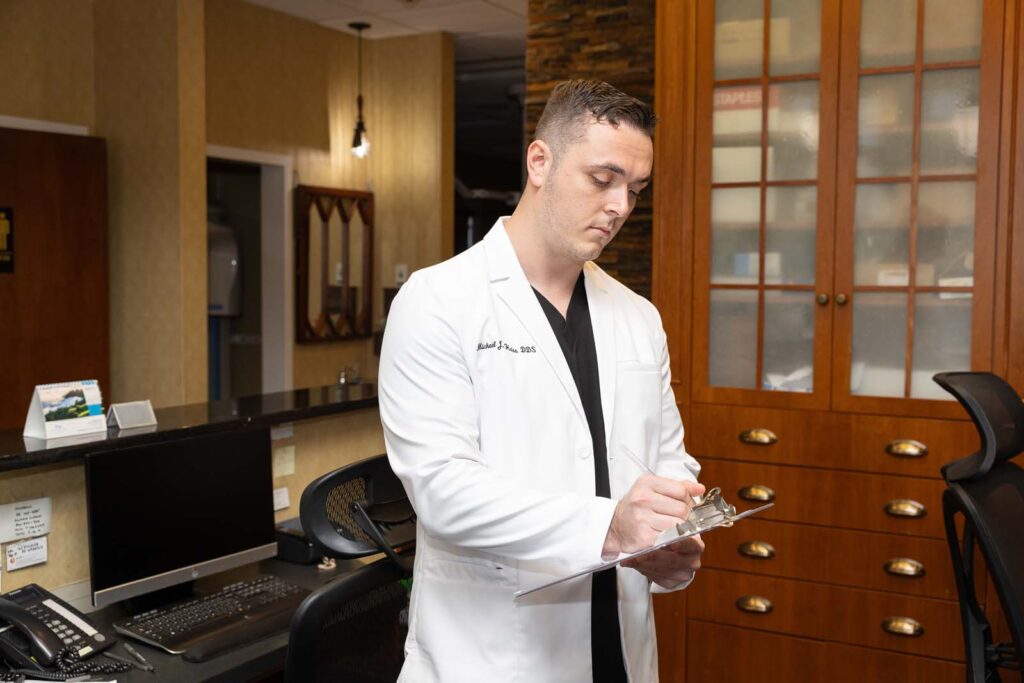 Dr. Heiss writing on a clipboard